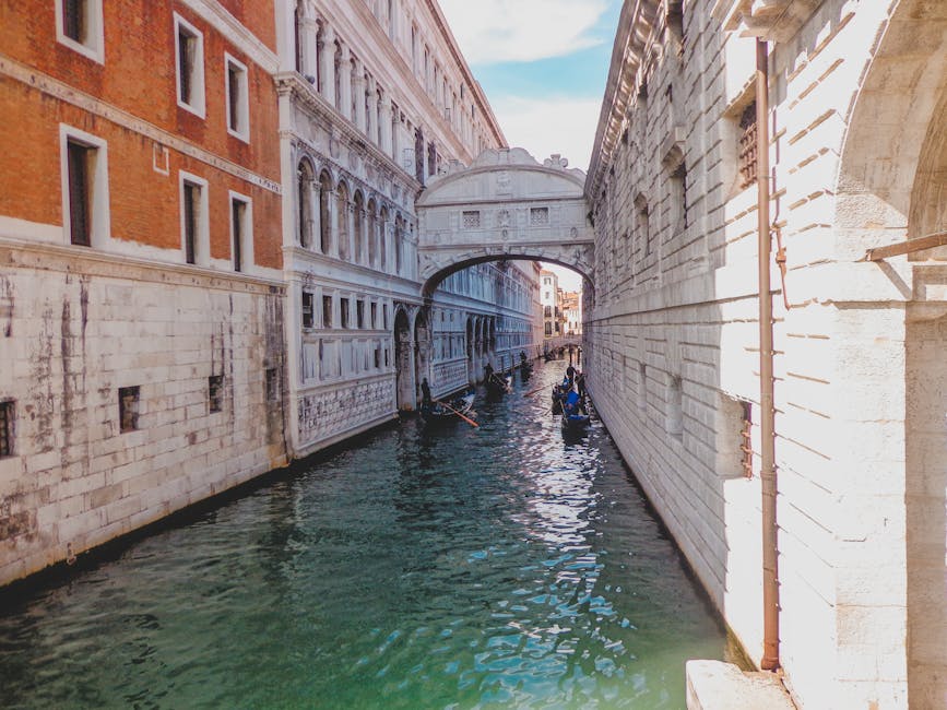 Bridge of Sighs over canal in Venice with gondolas