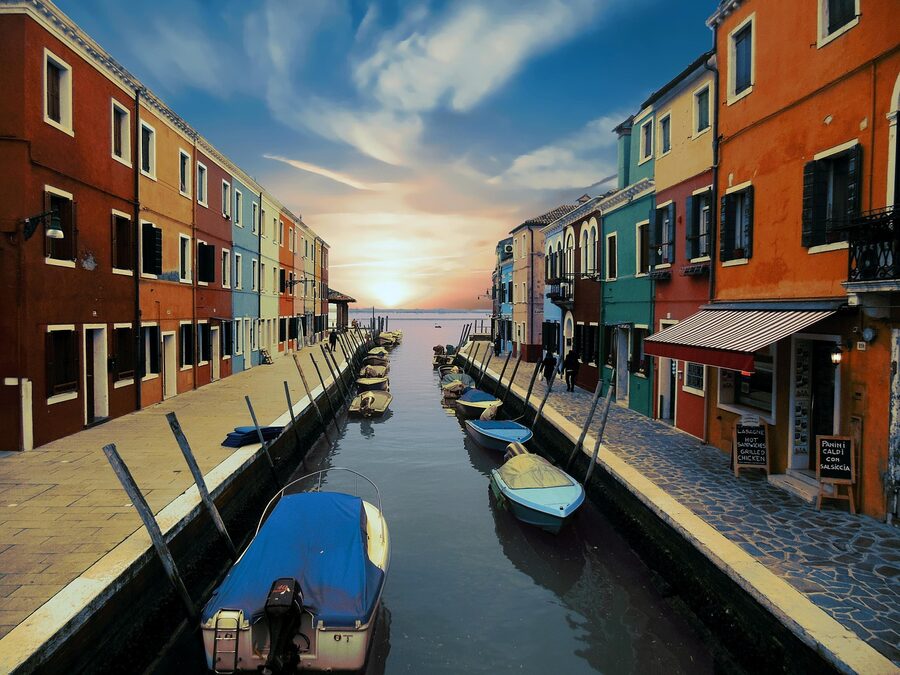 Burano homes and boats moored along a quiet canal