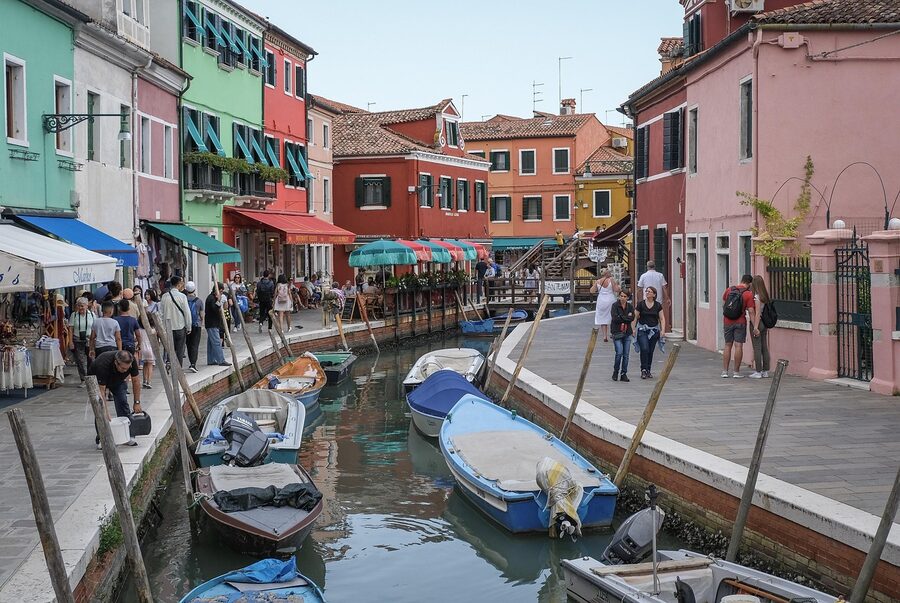 Burano summer canal overview with colorful waterfront and small boats