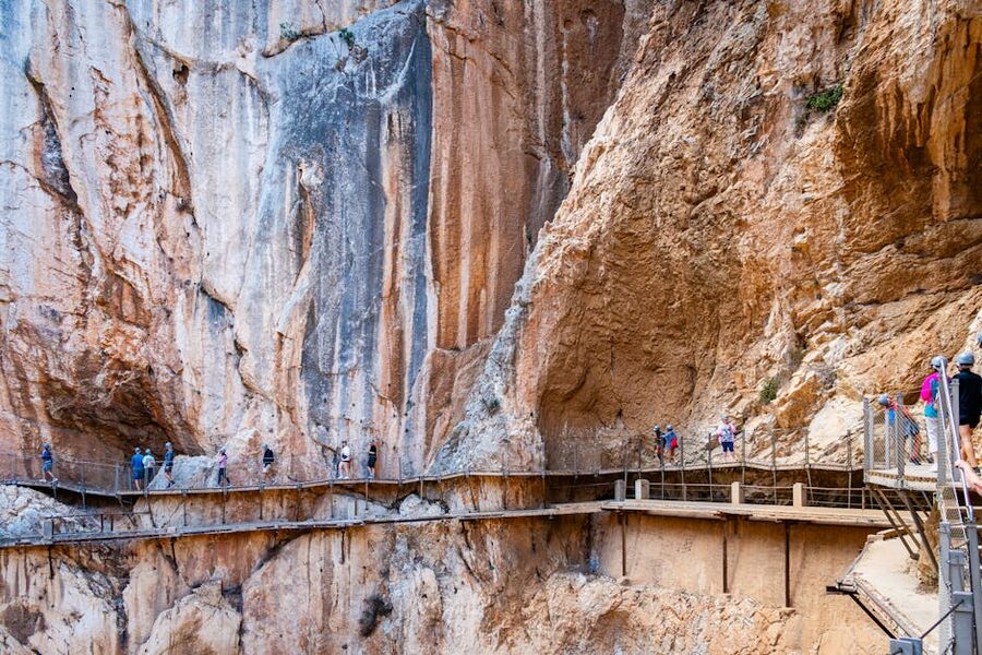 Hikers on the wooden boardwalk of Caminito del Rey high above the Gaitanes Gorge