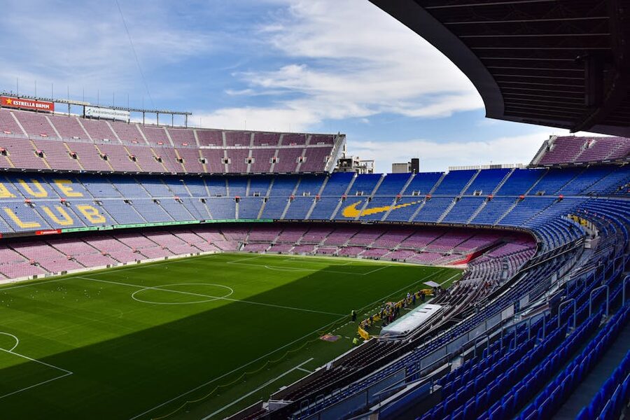 Camp Nou empty interior with blue seats and pitch visible