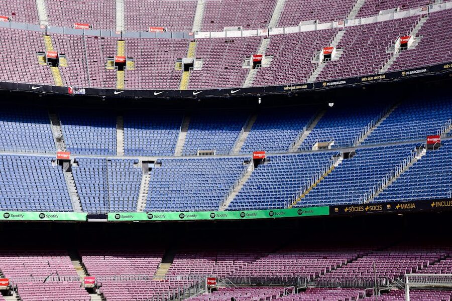 Camp Nou empty stands with soccer ball on pitch