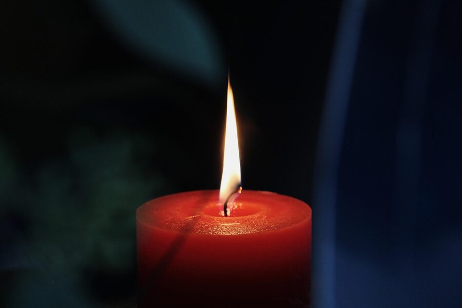 Candle flames in darkness atmospheric