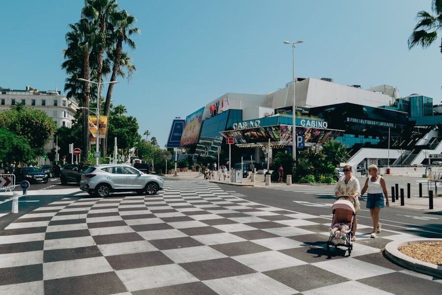 The Croisette boardwalk in Cannes with palm trees and the casino