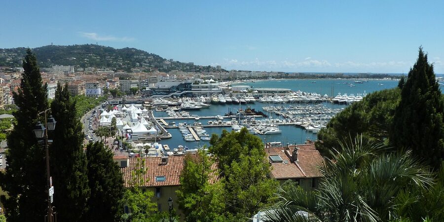 Cannes harbour at sunset with sailboats