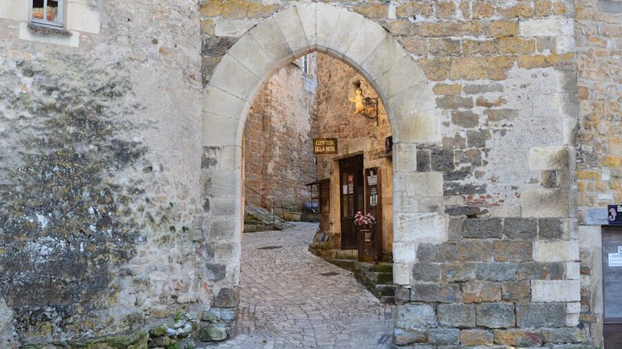Medieval stone alley with archway in Carcassonne