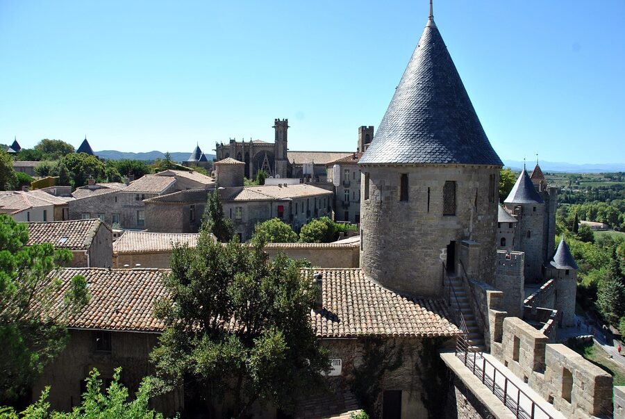 Stone restaurant on cobblestoned street in Carcassonne at night