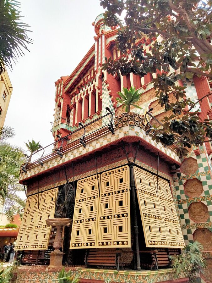 Casa Vicens west facade with bay window, green and white tile, palm-frond ironwork