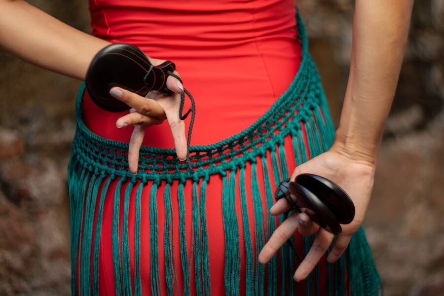 Flamenco dancer hands holding castanets close-up