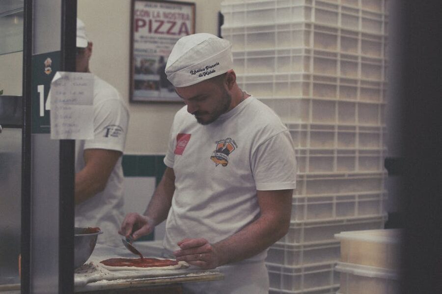 Pizza chef preparing dough in a Naples pizzeria