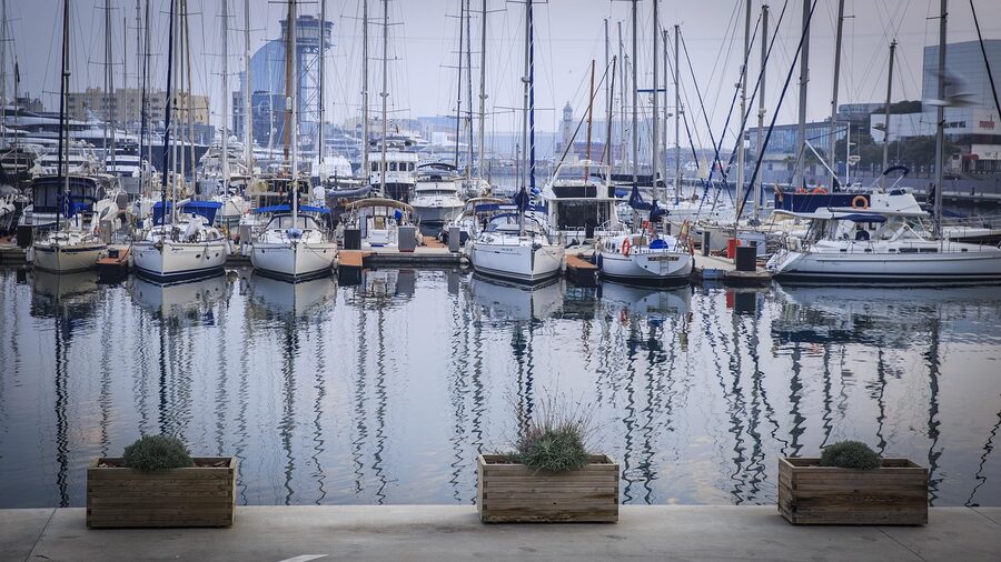 Barcelona port summer tourism with boats