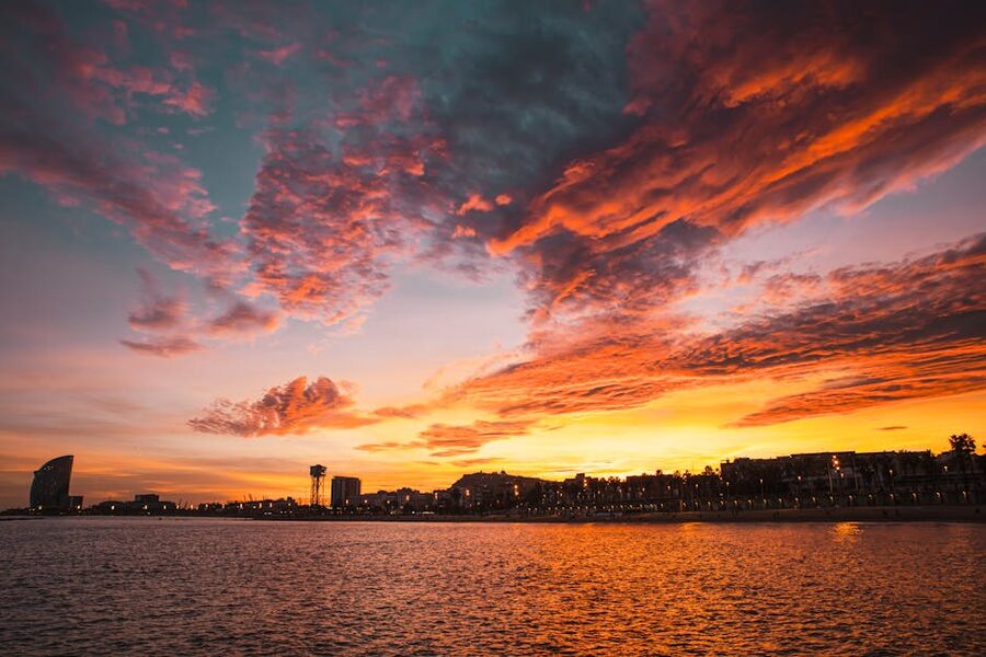 Sunset over Barcelona beach with dramatic clouds