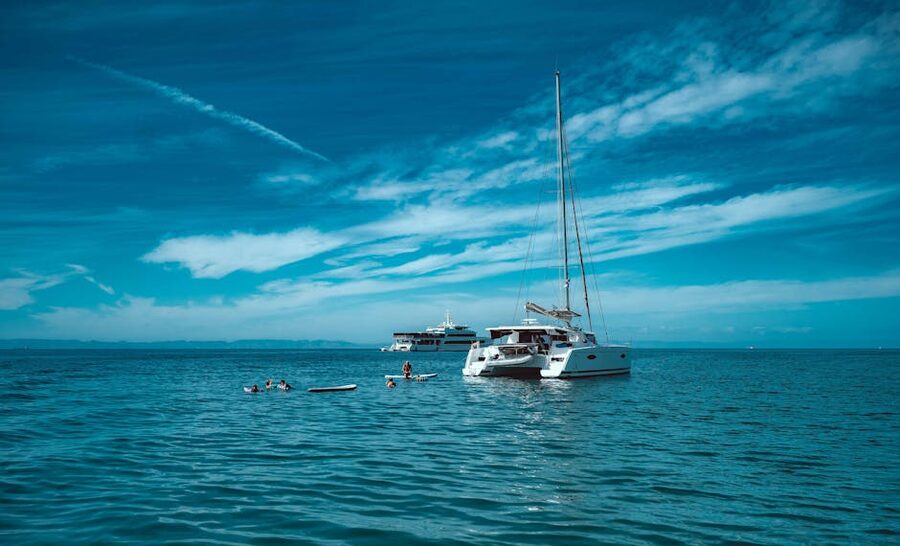 Catamaran with swimmers in the open sea