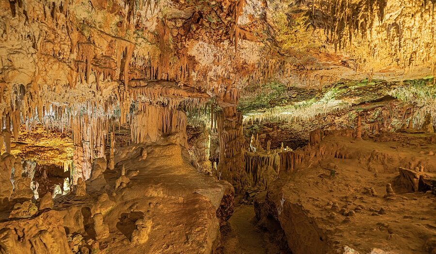 Illuminated cave walkway at Coves dels Hams