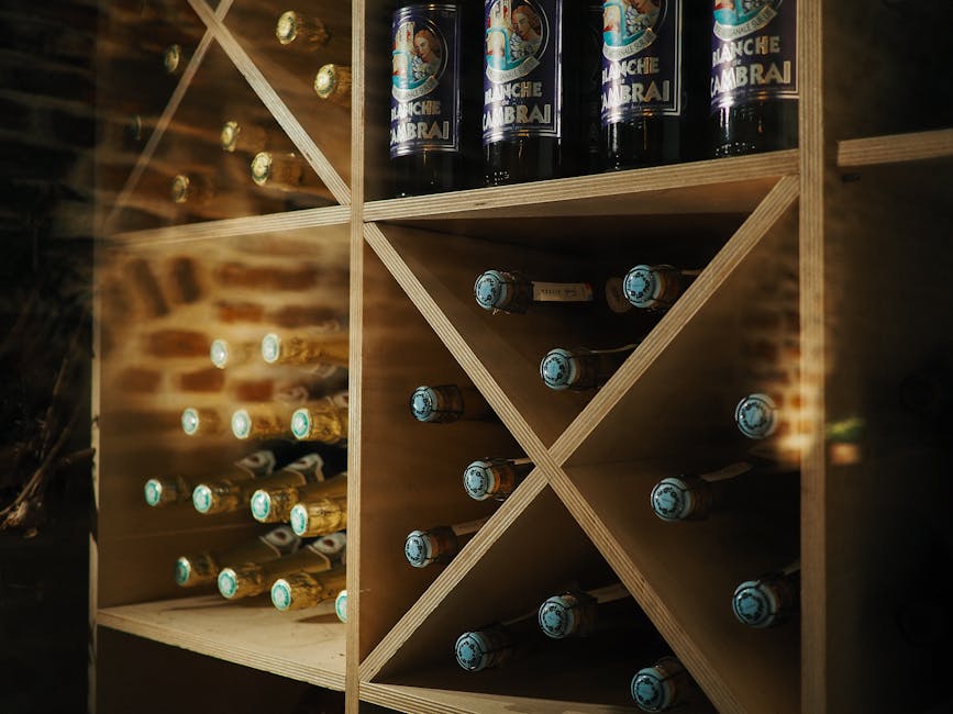Champagne bottles on wooden cellar shelves with brick wall