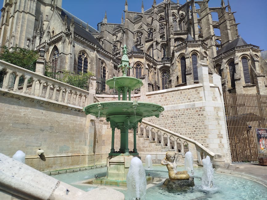 Reims cathedral exterior with fountain on the public square