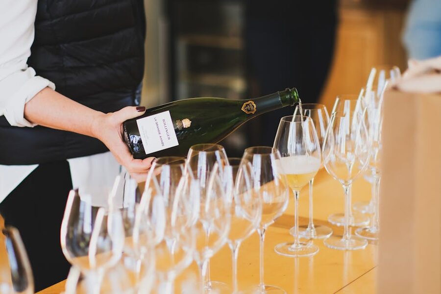 Champagne being poured into glasses at a tasting in Ay-Champagne