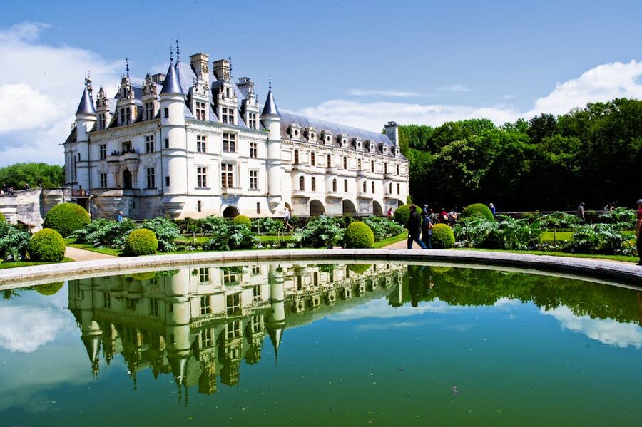 Chenonceau reflected over water in France gardens