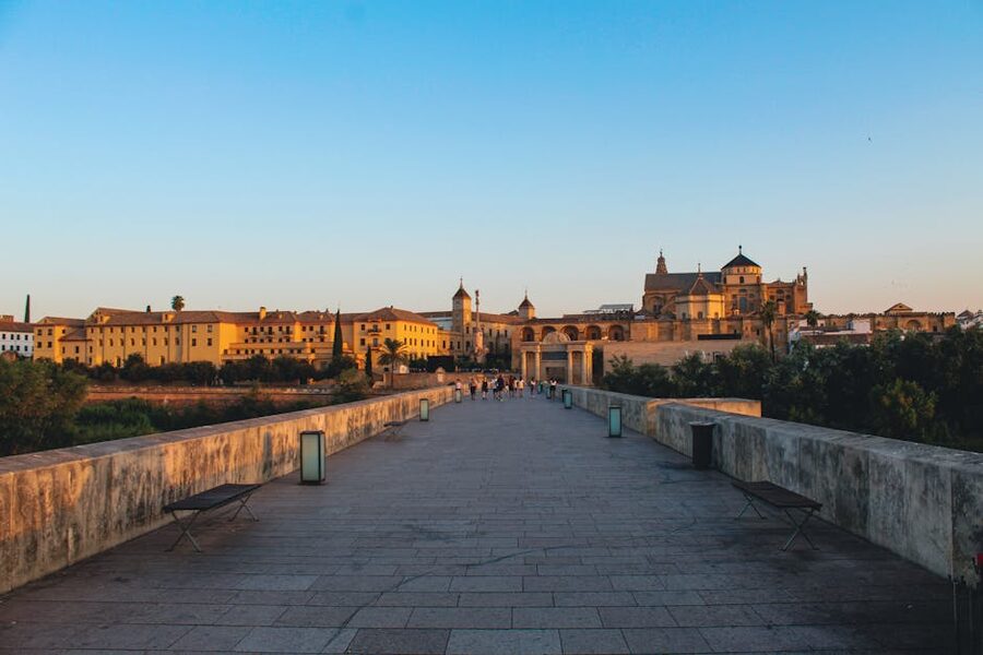 The Roman Bridge of Cordoba at golden hour with the Mezquita in the background