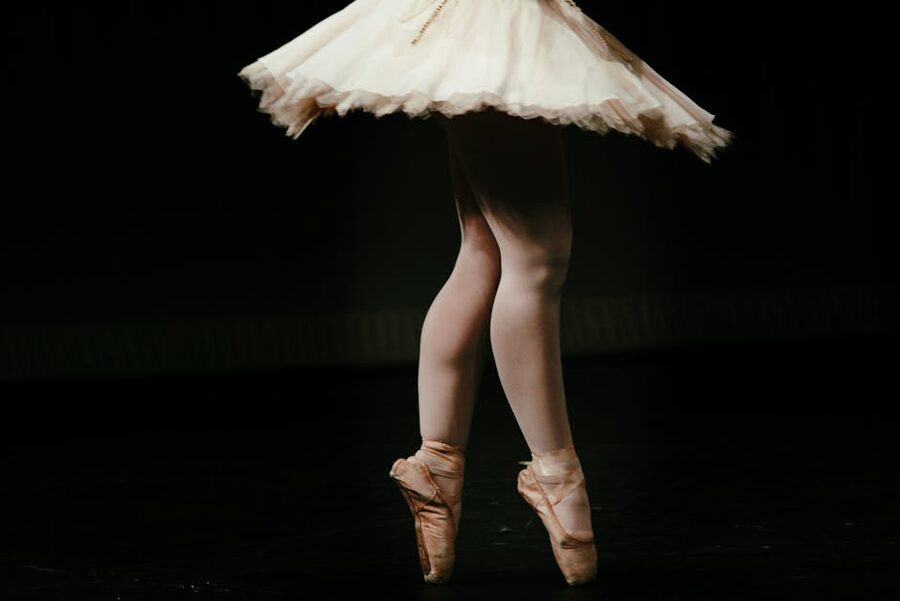 A dancer in pointe shoes performing on stage showing classical training