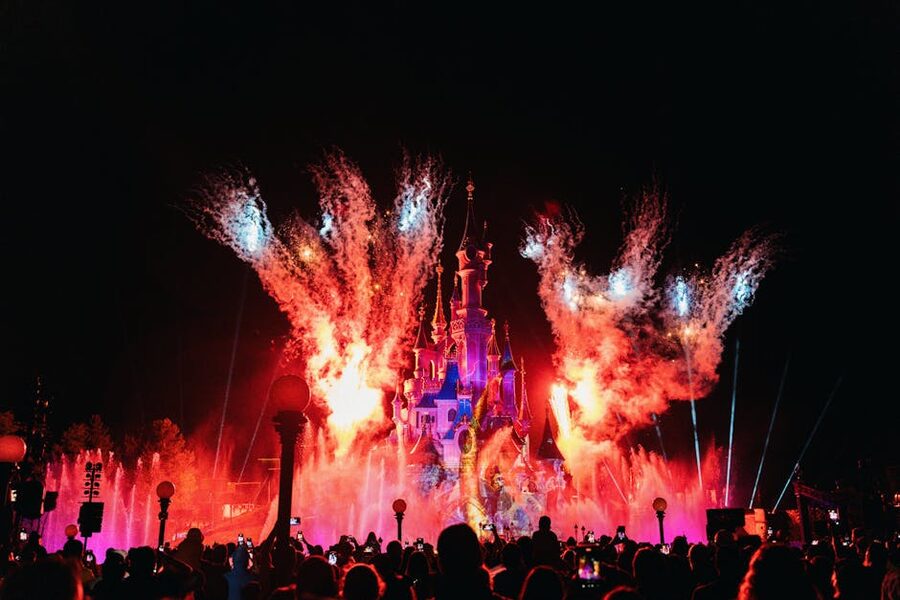Sleeping Beauty Castle illuminated during night fireworks at Disneyland Paris