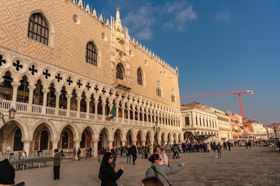 Tourists outside the Doges Palace Venice on a sunny day