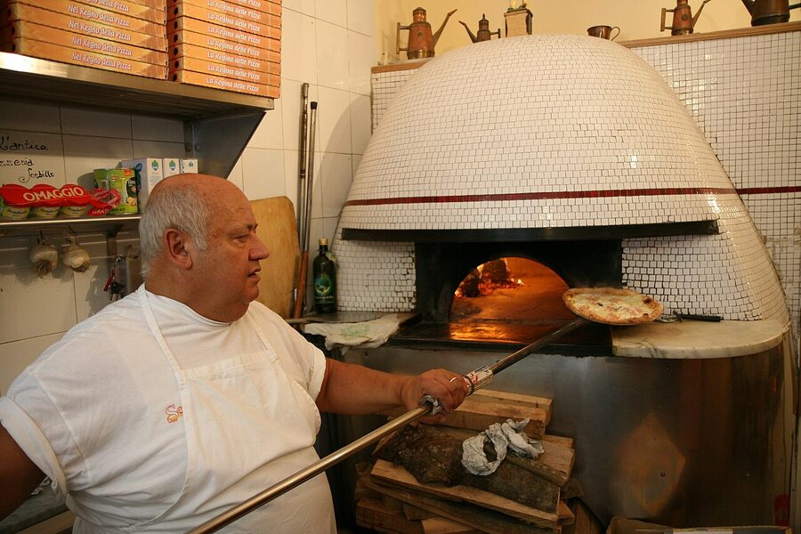 Pizza served at a Naples pizzeria, table set for one diner