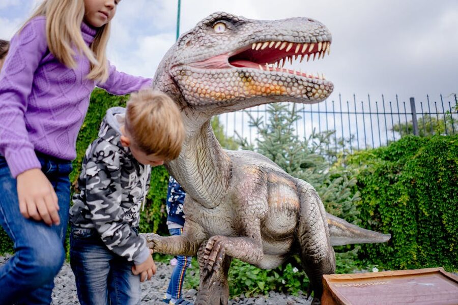 Children playing at a museum dinosaur exhibit family activity