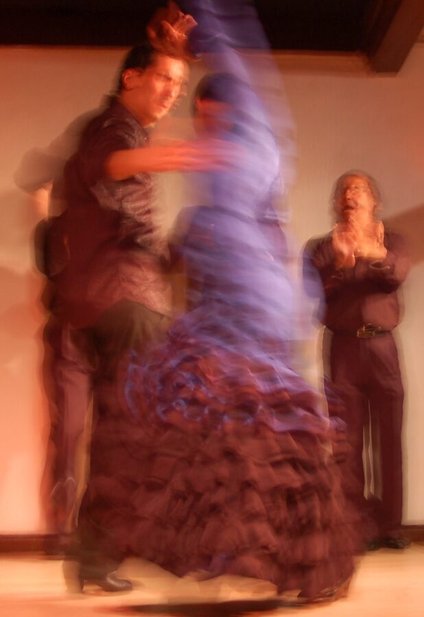 A flamenco singer at a Madrid tablao with the guitarist in the background