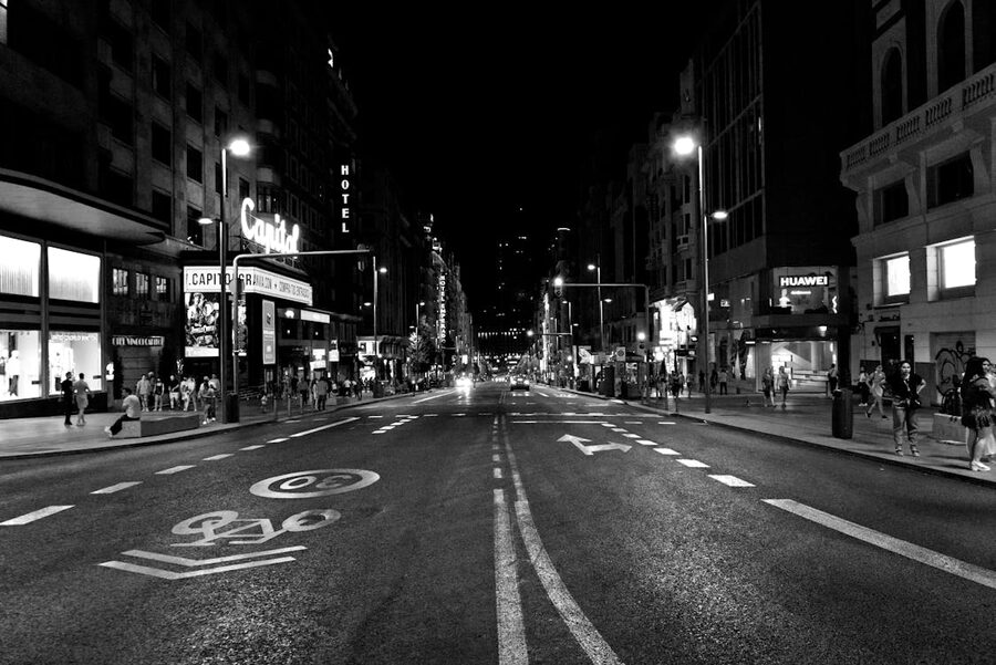 Gran Via Madrid at night with neon lights and crowds