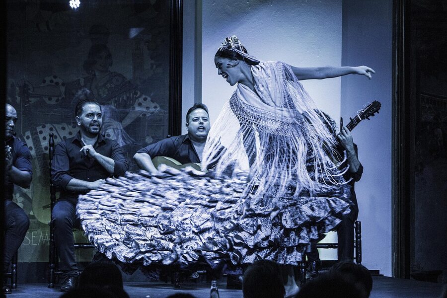 A tablao flamenco show in progress with dancer and musicians