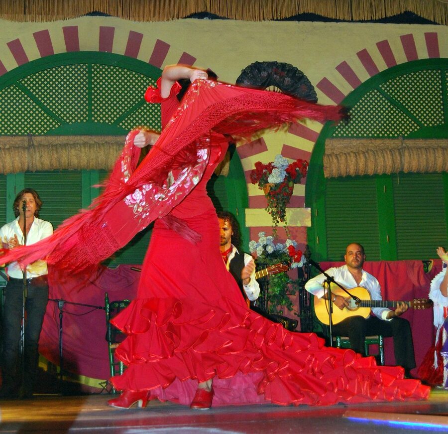 Flamenco dancer with red shawl on stage