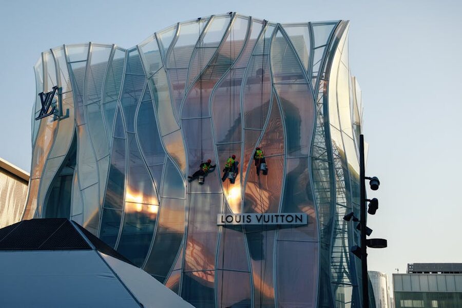 Workers cleaning the glass facade of the Louis Vuitton Foundation in Paris