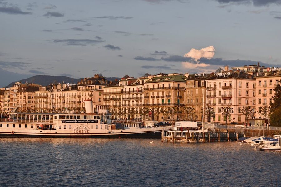 Geneva waterfront with the Jet d'Eau in the distance at sunset