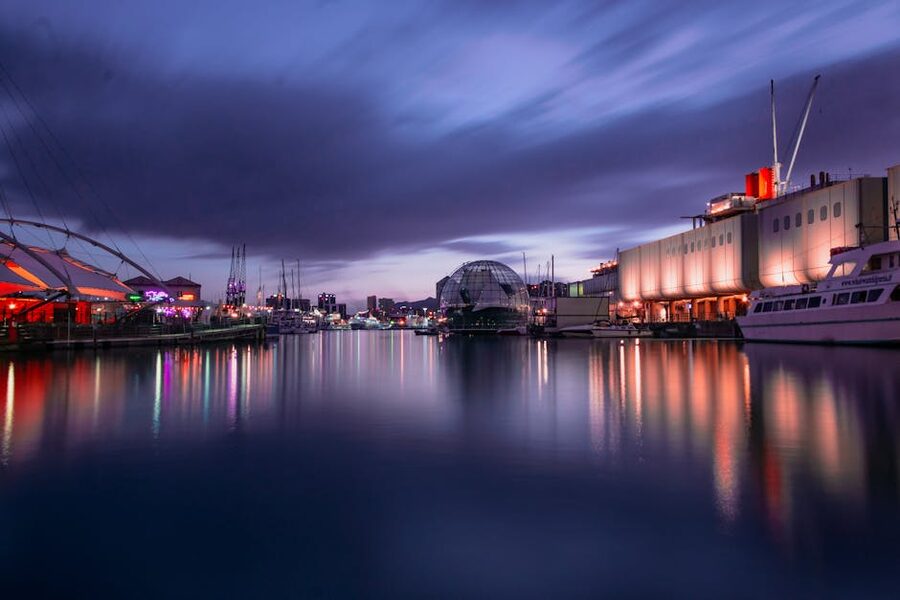 Genova harbour at twilight with reflected lights on the water