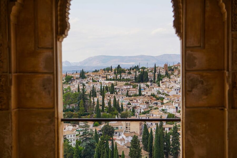 Granada through Alhambra arch with view of city