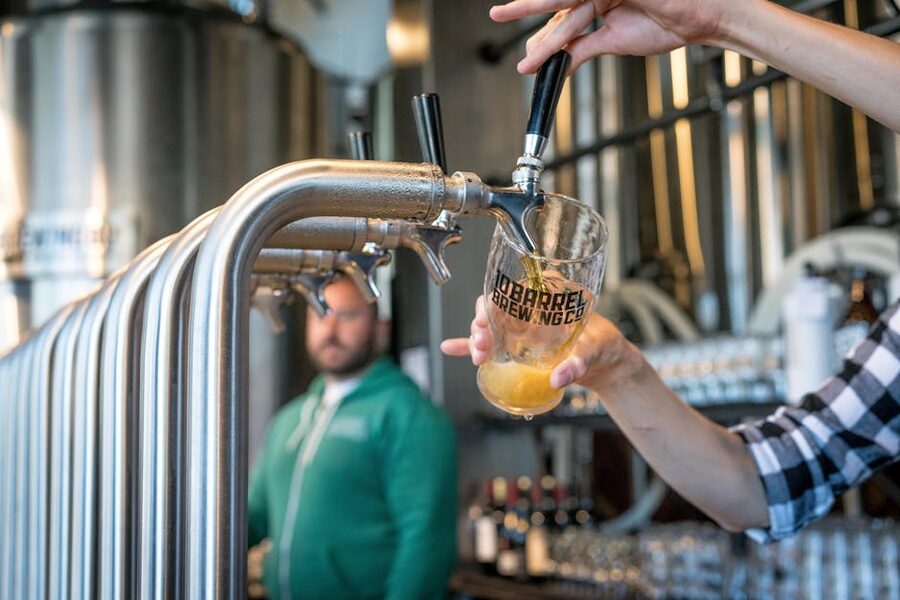 Beer pouring into glass at brewery taproom