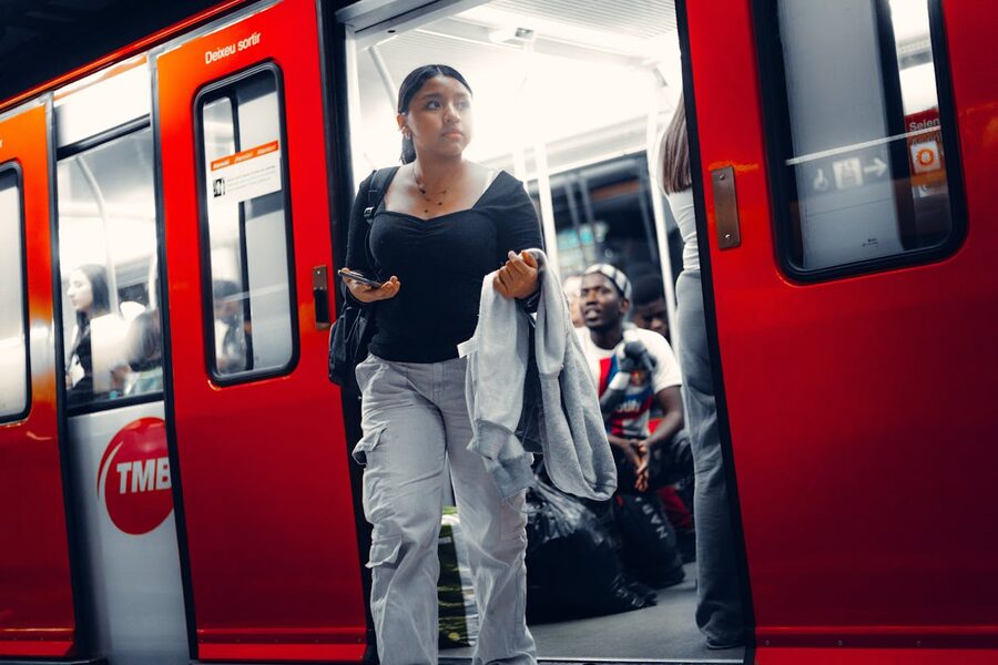 Woman exits red TMB subway train Barcelona