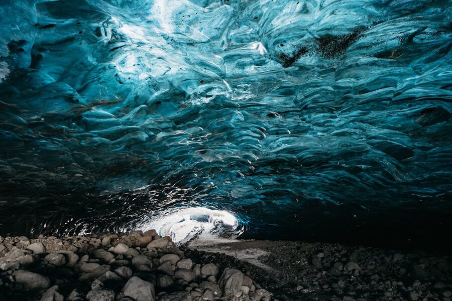 Inside an Alpine glacier ice cave with blue ice formations