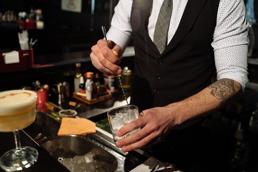 Bartender preparing a cocktail with ice cubes