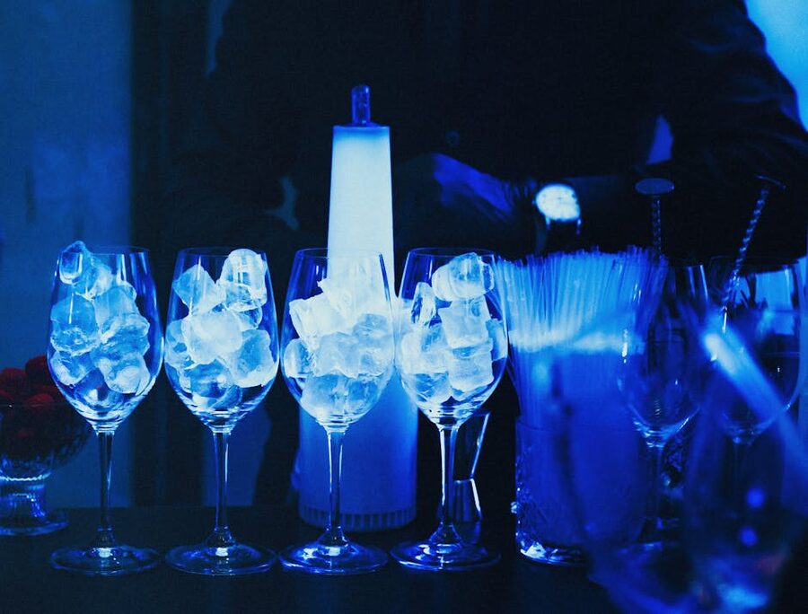 Ice glasses lit blue at a frozen-themed bar