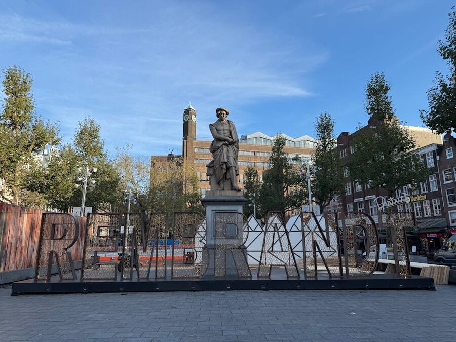 Statue of Rembrandt at Rembrandtplein in Amsterdam at dusk