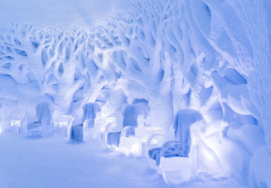 Ice bar interior with deep blue lighting and ice furniture
