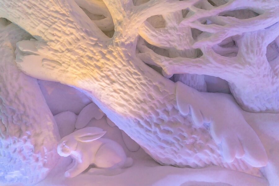Ice room with carved sculptures and atmospheric lighting