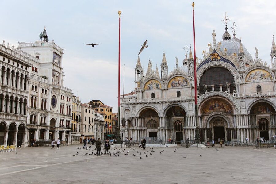 Piazza San Marco with tourists and pigeons in front of St Mark's Basilica