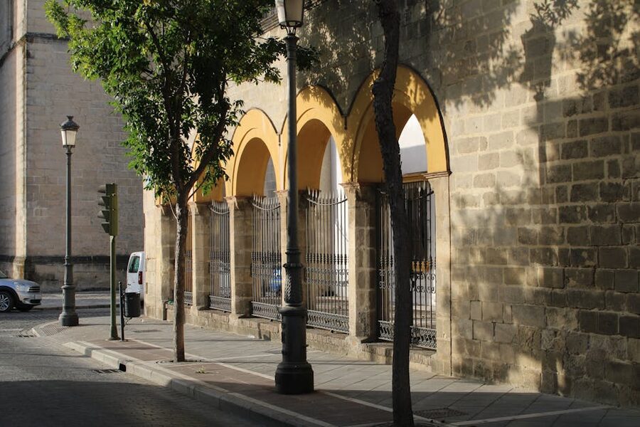 An arched facade and street in Jerez de la Frontera