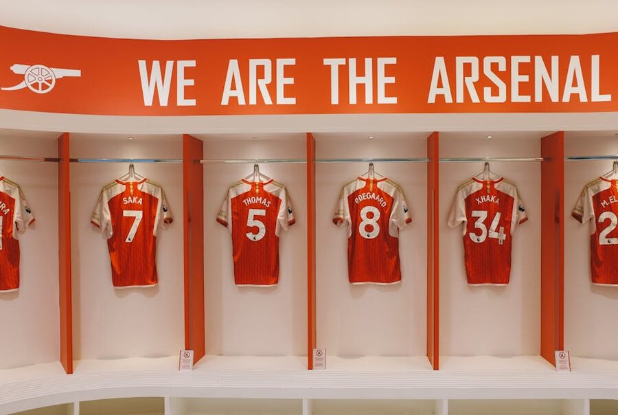 Football club jerseys on display in a stadium locker room