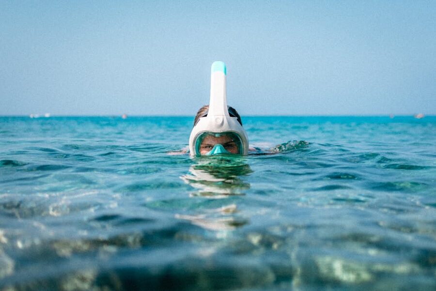 Snorkeler in clear blue sea