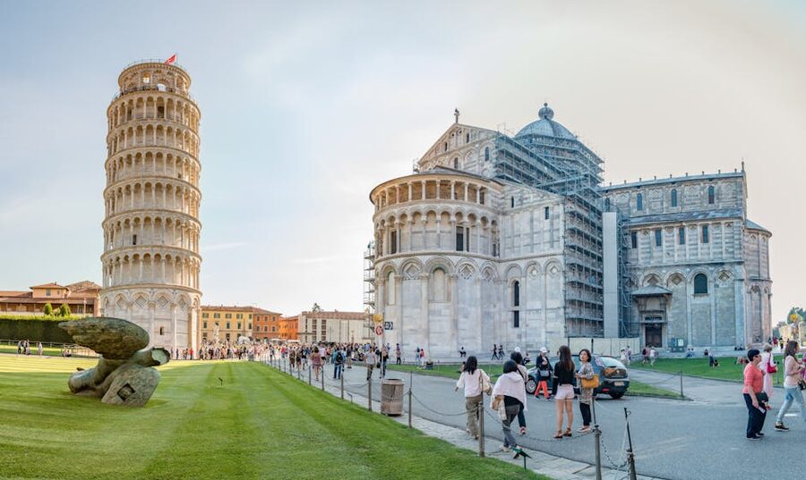 Tourists on Piazza del Duomo with the Leaning Tower of Pisa and the Pisa Cathedral
