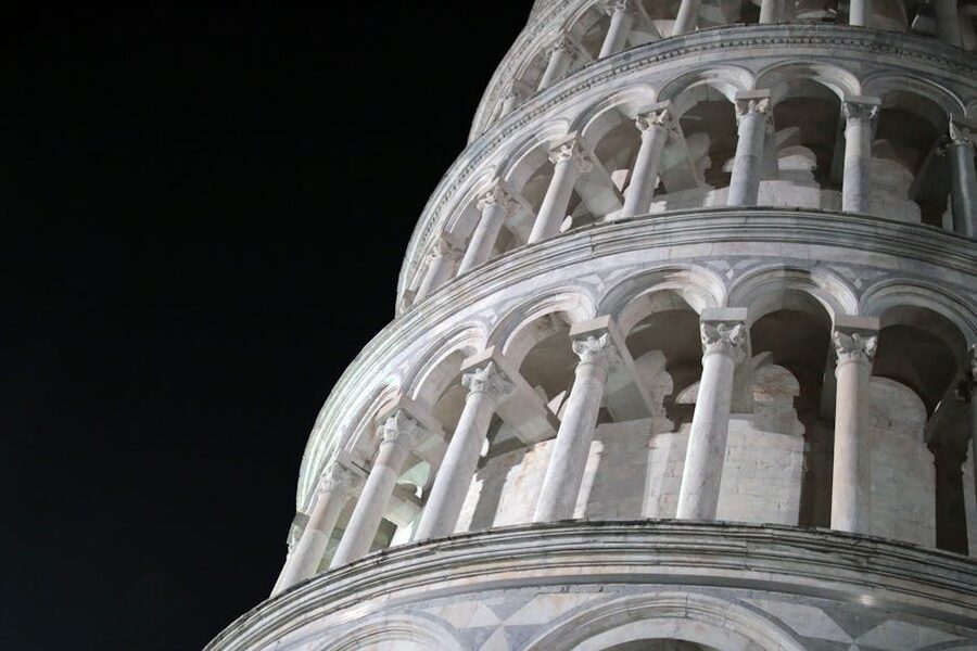 The Leaning Tower of Pisa illuminated against a night sky